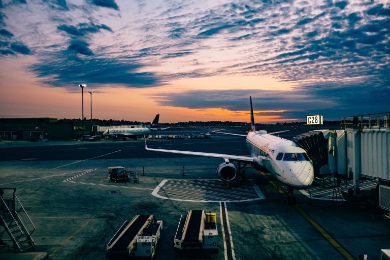 Airplane at Airport Gate with Sunset