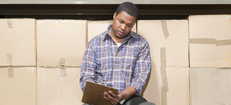 Warehouse Worker Looking at Clipboard