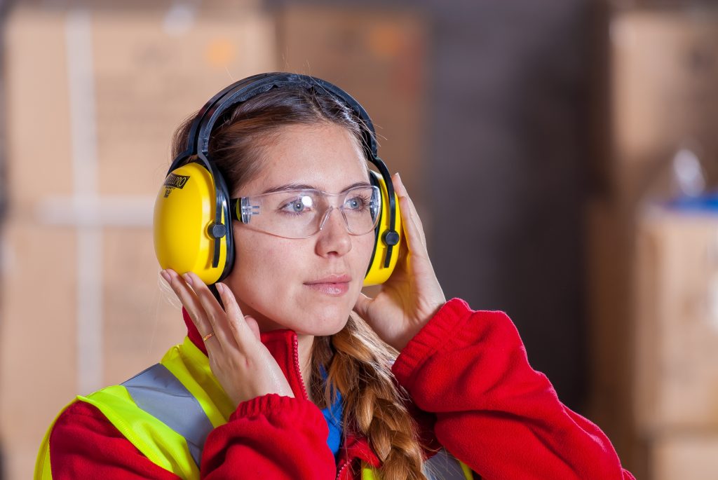 Women with Ear Protection and Safety Vest and Safety Glasses