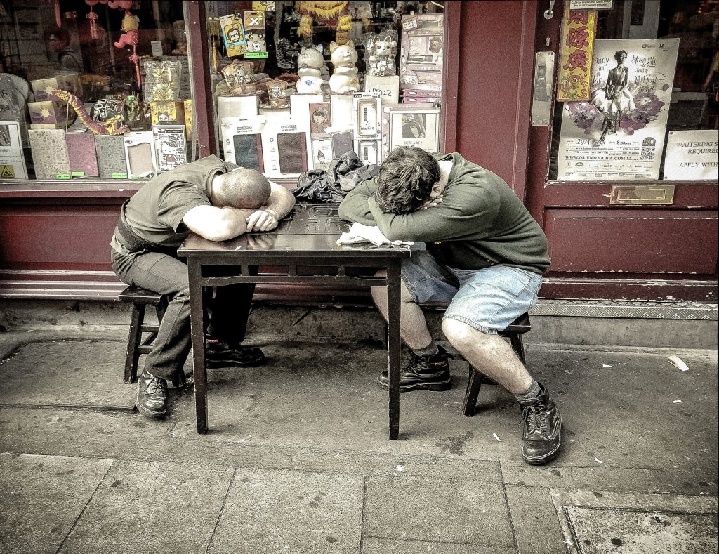 Two Workers Sleeping at a Table